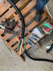 An industrial cable spread out with tools to inspect and repair it.