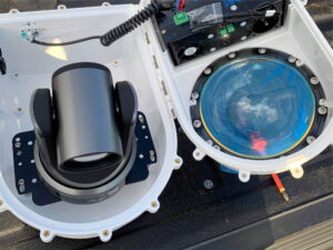 A close-up view of an electrical control panel with multiple switches, buttons, and indicators, indicating a complex system used for monitoring and controlling industrial processes.